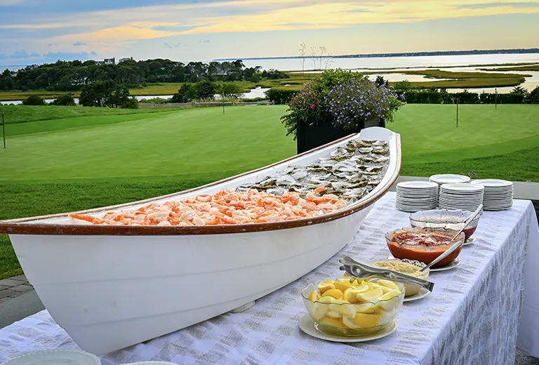 Table filled with shrimp and oysters.
