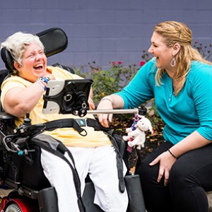 two adult Citizen program participants sitting and laughing