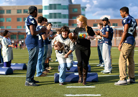 Group of Promoter Chapter members playing football on a field