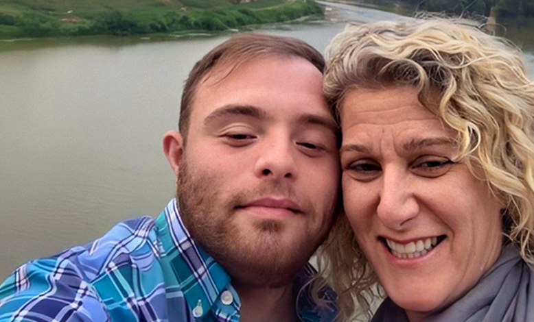 Andy Greene with his mother, Nina Greene smiling in front of a lake