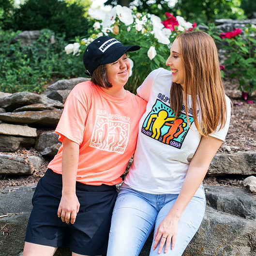 Best Buddies Friendship Program participants Maggie and Jenna smiling outside