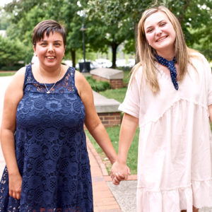 Best Buddies Citizens pair holding hands and smiling outside