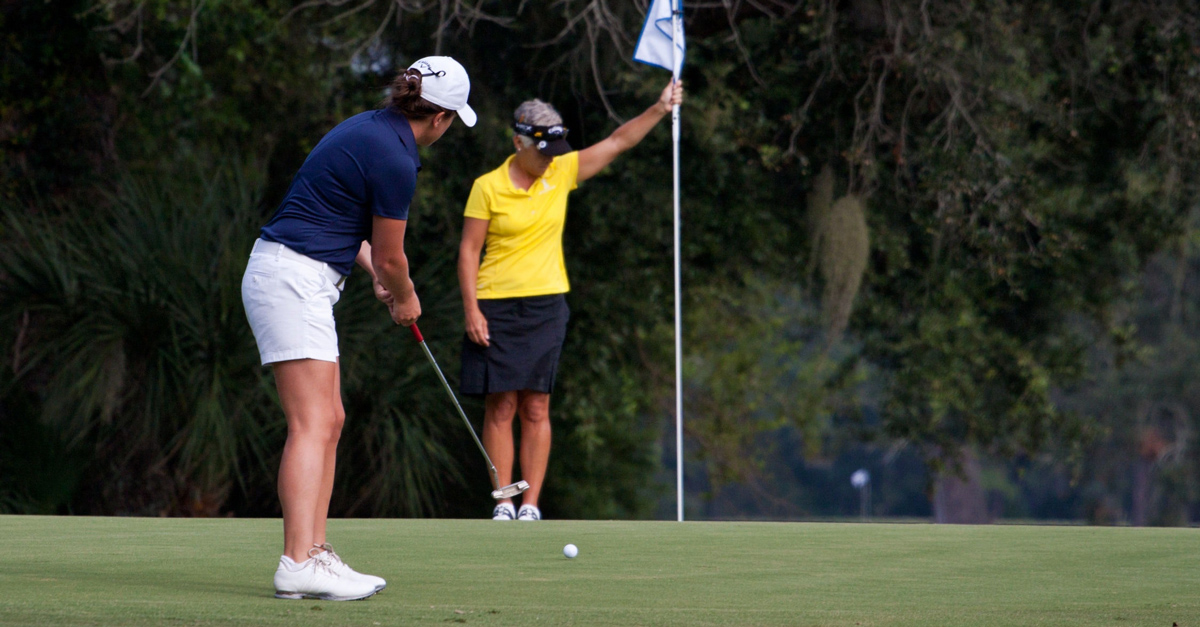 Two women playing golf