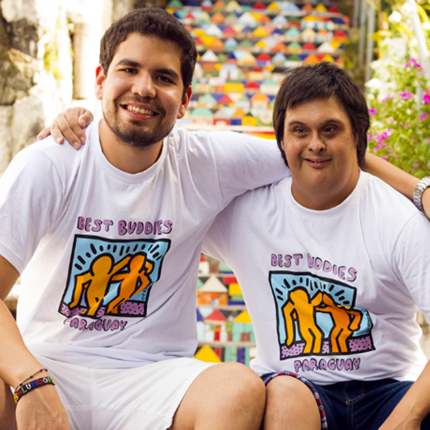 A pair of Best Buddies Paraguay Friendship Guy Participants embrace each other