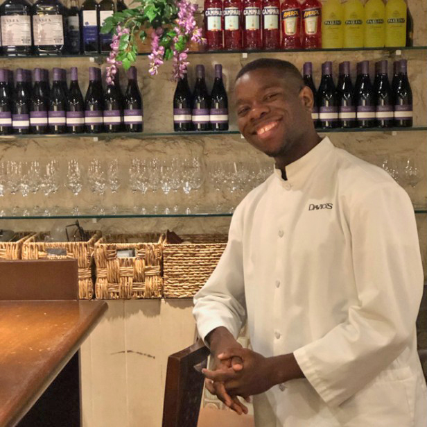 Best Buddies Jobs Participant Joseph Parker working at Davios restaurant, smiling and wearing a chef's uniform.