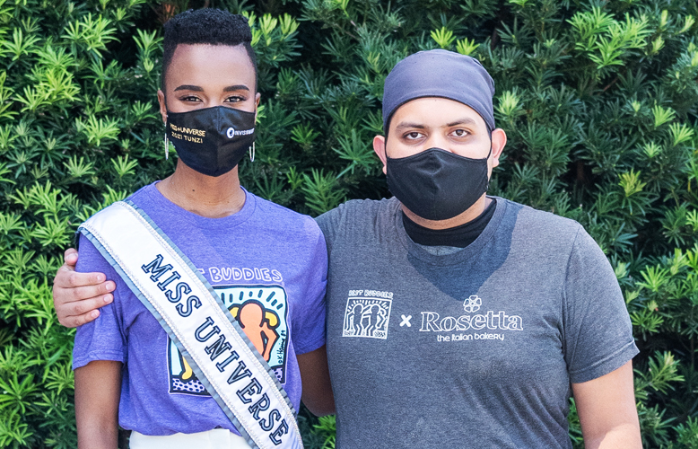 Miss Universe 2020 poses with a Rosetta Bakery Employee in Miami, Florida.