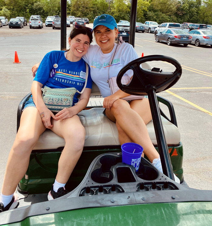 Citizen pair Chloe and Vanessa sitting in a golf cart