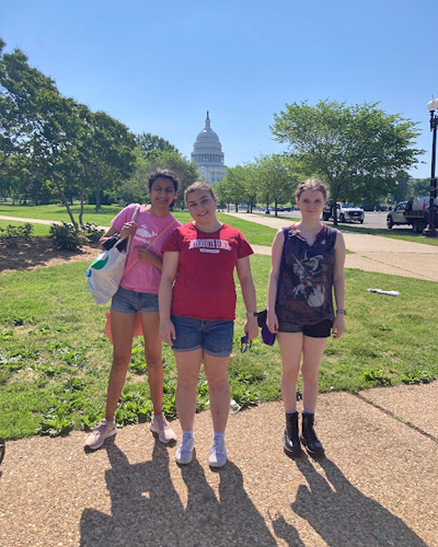 Three Best Buddie's girls Sleepover participants pose in front of the Capital Building in Washington, D.C. on a sunny day.