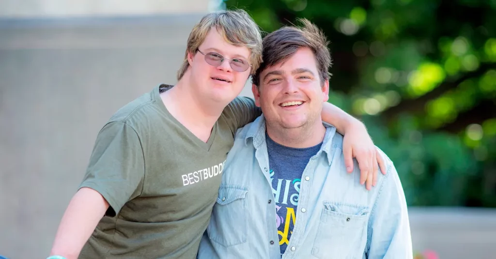 Best Buddies Citizens pair Bryan and Will smiling while posing next to each other