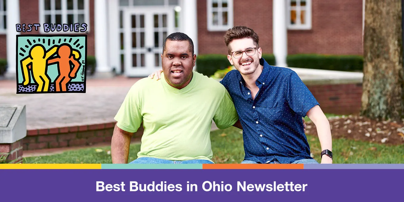 Two male Best Buddies participants smiling next to each other