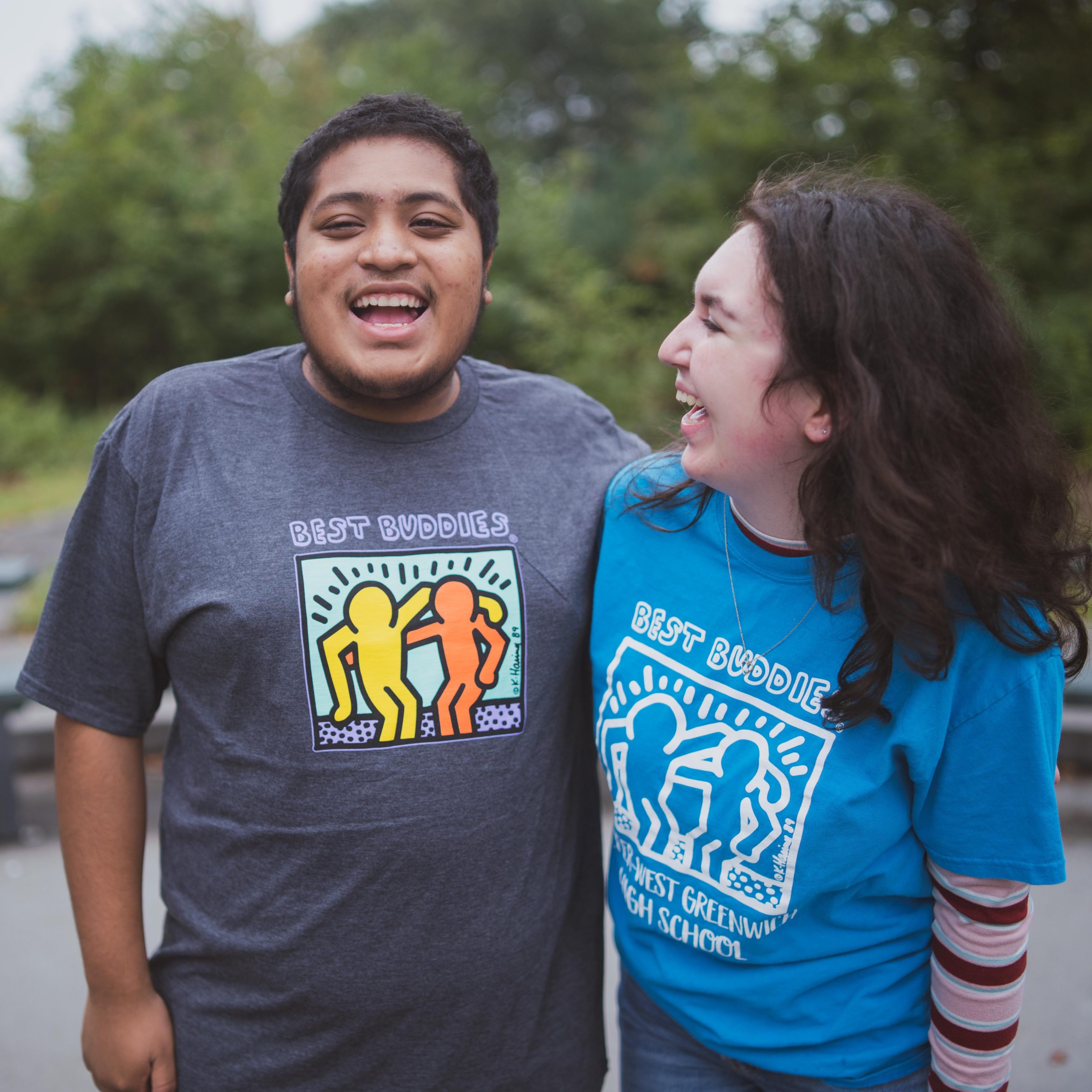 A buddy pair standing outside laughing