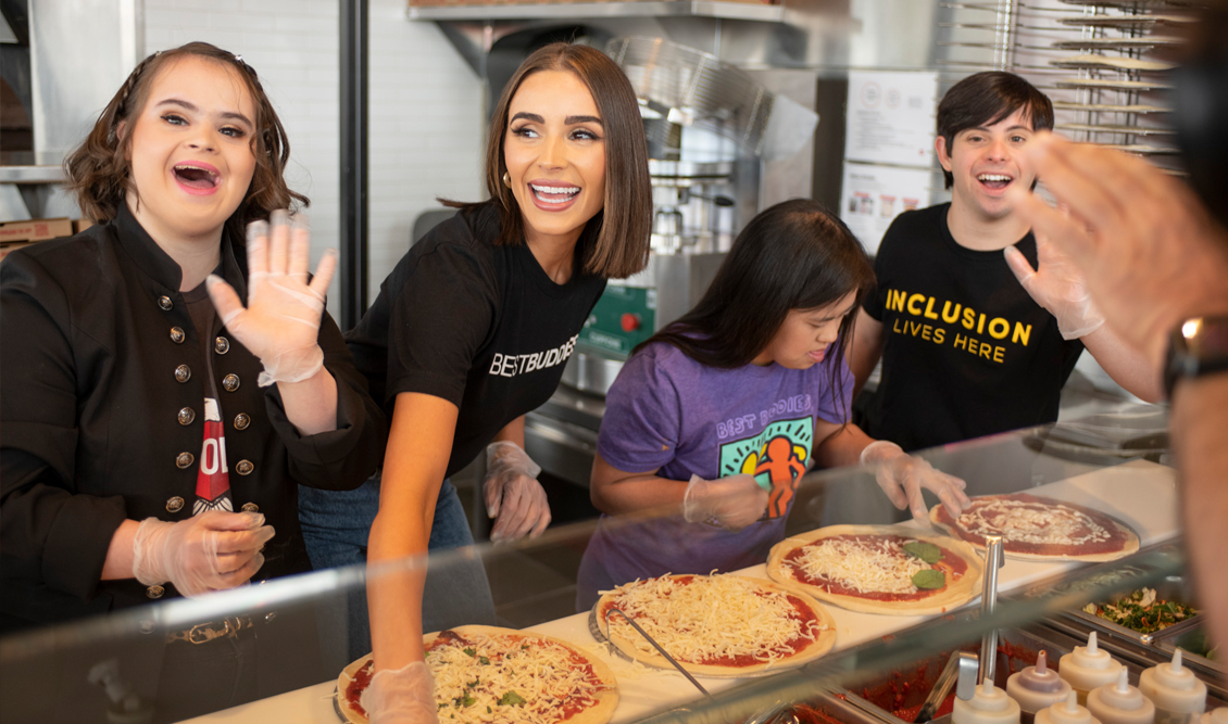 Best Buddies Supporter, Olivia Cumpo, two female and one male Best Buddies participants, are creating pizzas at MOD's Pizza.