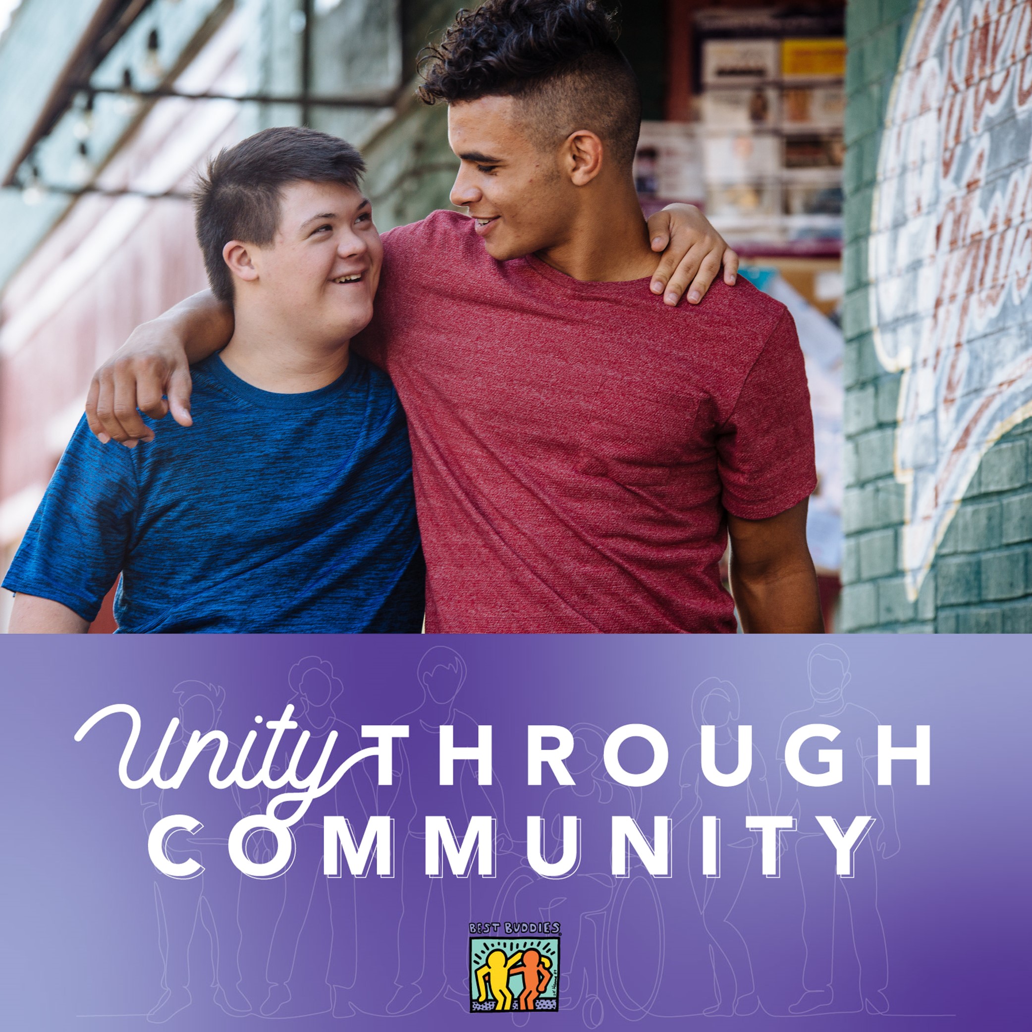 Two male Best Buddies Friendship participants are smiling and hugging each other.