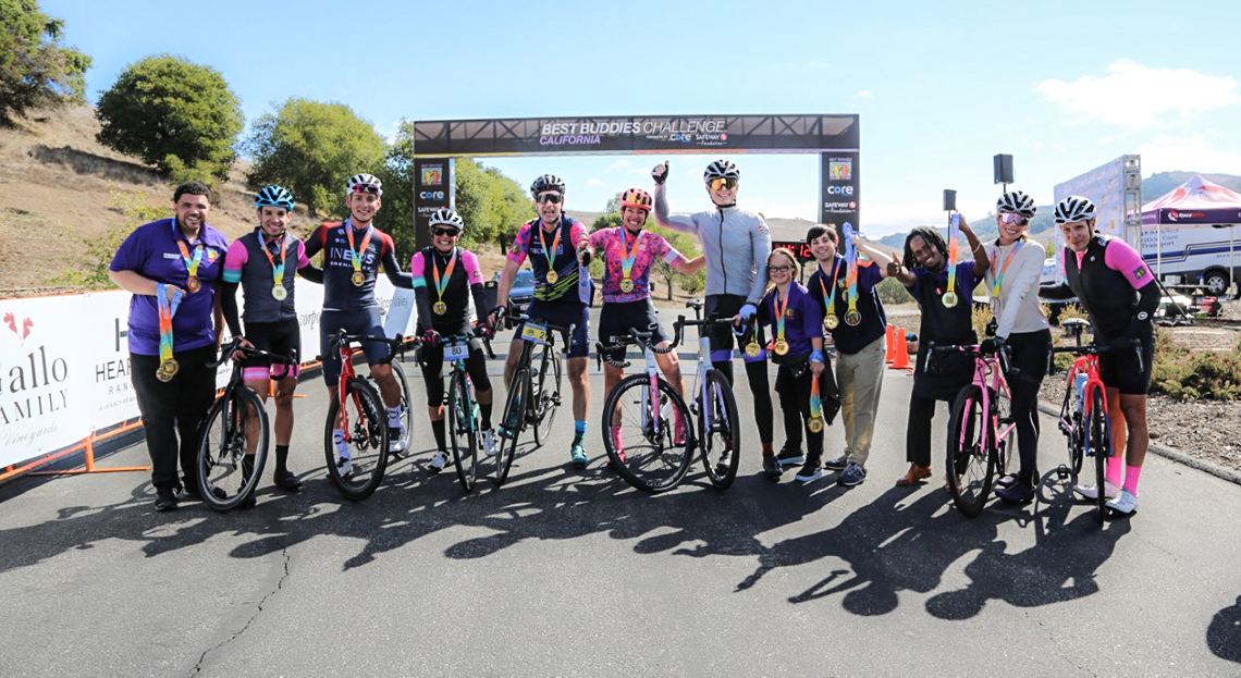 A group of Best Buddies Challenge: California cyclists and program participants pose by the Finish line.