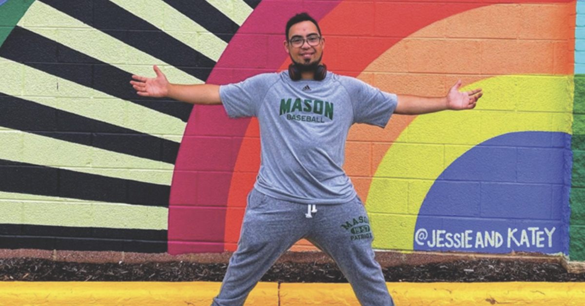 Alex Bolden in front of a mural
