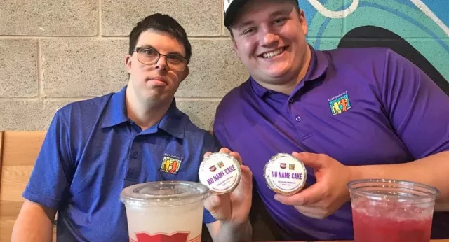 Chris Lindstrom, Best Buddies supporter and Friendship participant, is sharing drinks and snacks with his best buddy.