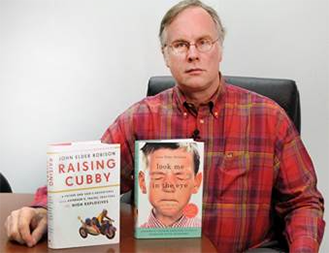 Author John Elder Robison proudly displaying two of his bestselling books.