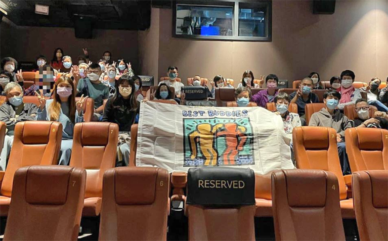 Best Buddies in Hong Kong partiticpants are in a theatre preparing to watch a movie.