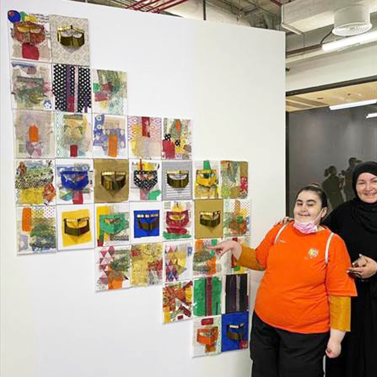 A buddy pair from Best Buddies Qatar enjoys a nice outing together at an Art Exhibition.