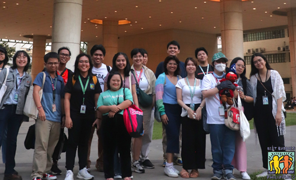 Best Buddies Philippines participants gather outside a movie theater for a photo op.