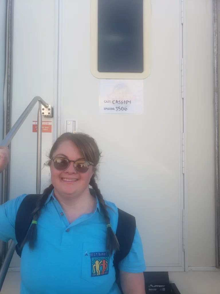 Cassidy Bauer standing in front of trailer.
