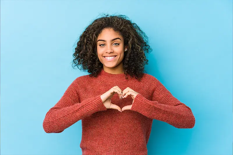 woman making heart sign with hands