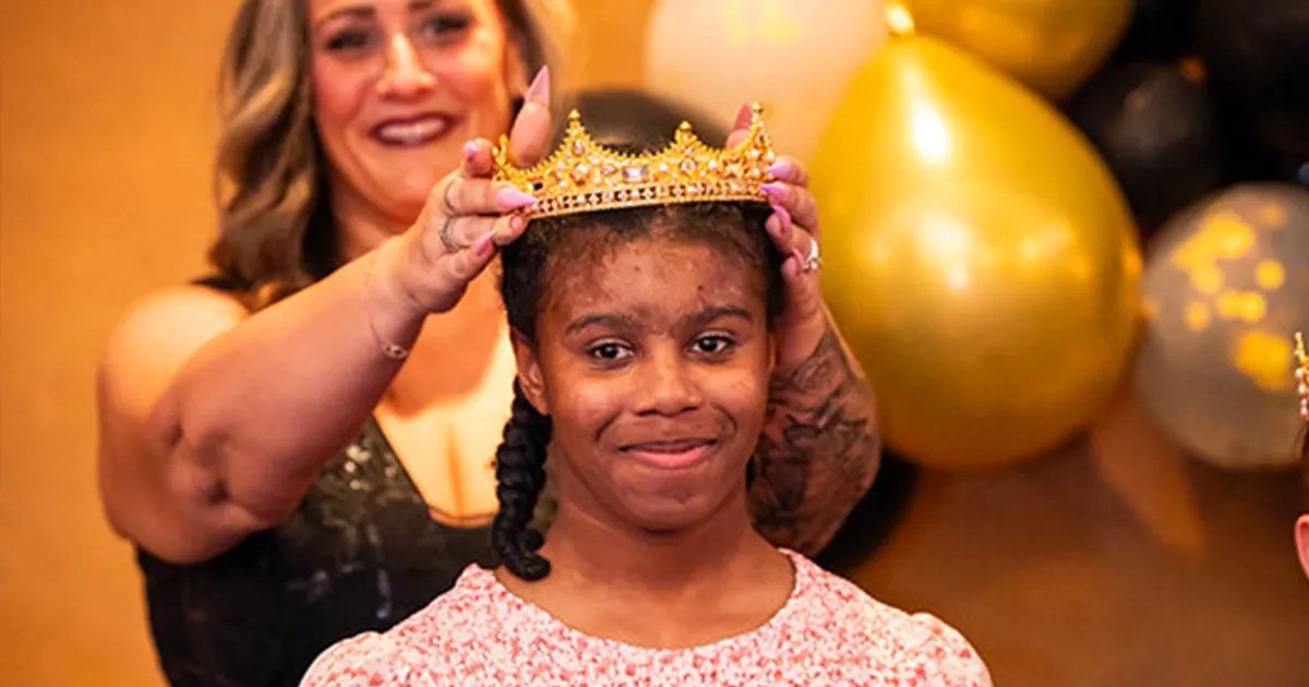 young female best buddies participant being crowned
