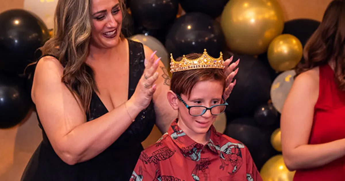 young male best buddies participant being crowned