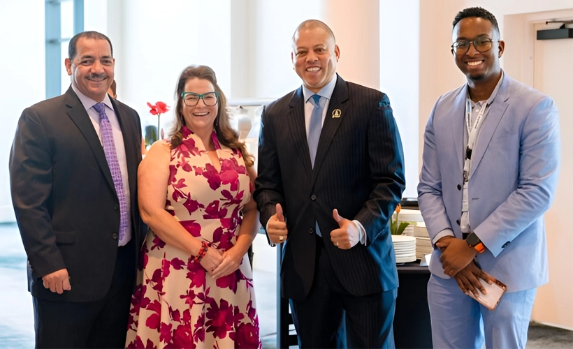 Best Buddies programme to launch in Cayman schools - image Four leaders at the Uncharted conference—Education Minister Rolston Anglin, Inclusion Cayman CEO Shan Harriman, Premier André Ebanks, and facilitator Nathan Chesney—standing together and smiling indoors.