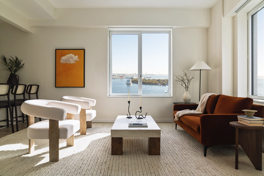 Living - NY, NY SoMA Living Room Bright apartment living room with modern furniture and large windows overlooking waterfront city views.