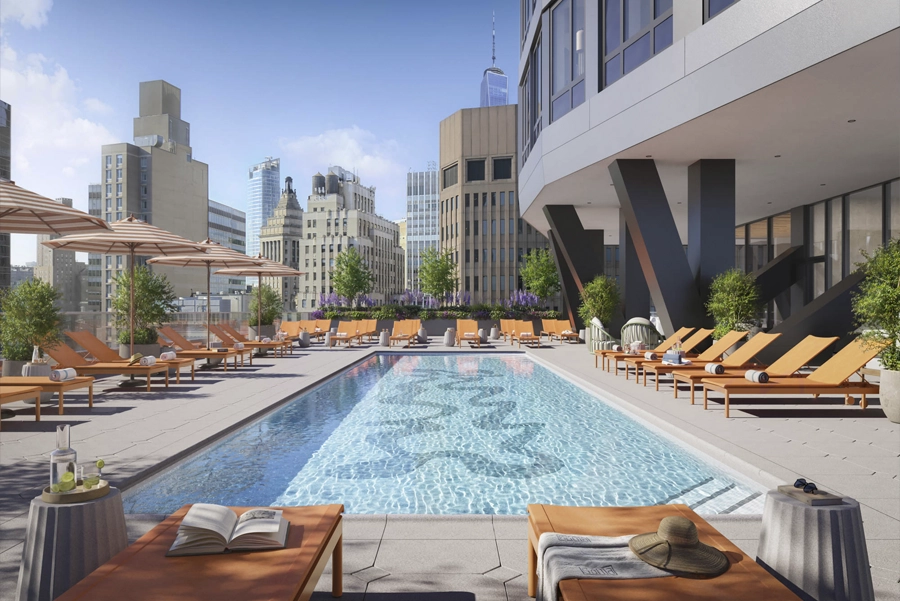 Living - NY, NY SoMA Pool Rooftop pool with lounge chairs and city skyline views at luxury NYC apartment building.