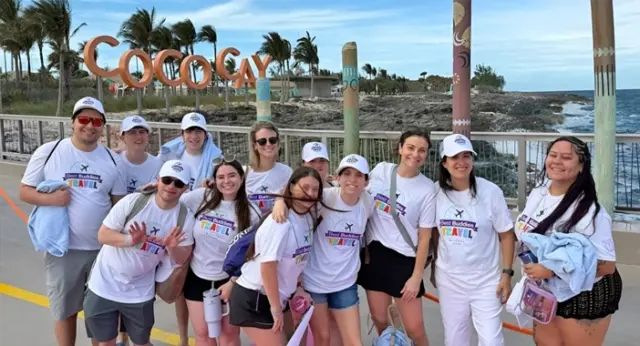 Group of Best Buddies participants posing together at CocoCay during a travel experience.