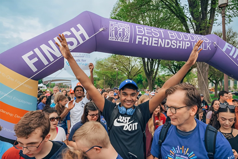 Best Buddies to Host 5th Annual Ed Ansin Best Buddies Friendship Walk at loanDepot Park - Top Image Participants crossing the finish line at the Best Buddies Friendship Walk event.