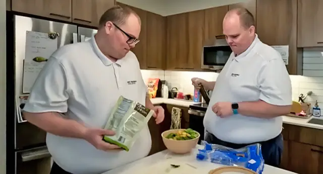Nathaniel and Austin Lewin prepare a meal together in their apartment kitchen as participants in the Best Buddies Living program, which supports adults with intellectual and developmental disabilities in building independent living skills.