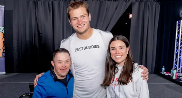 Best Buddies supporter poses with New England Patriots quarterback Drake Maye and Ann Michael Maye at a Best Buddies event.