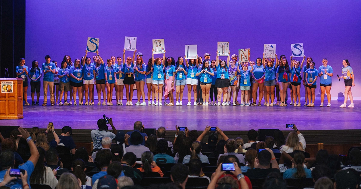 group of siblings participants on stage at leadership conference