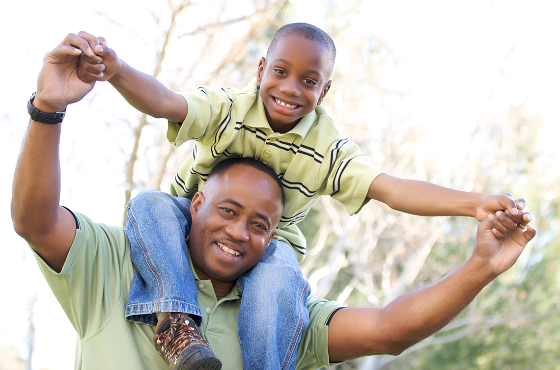 father with son on his shoulders