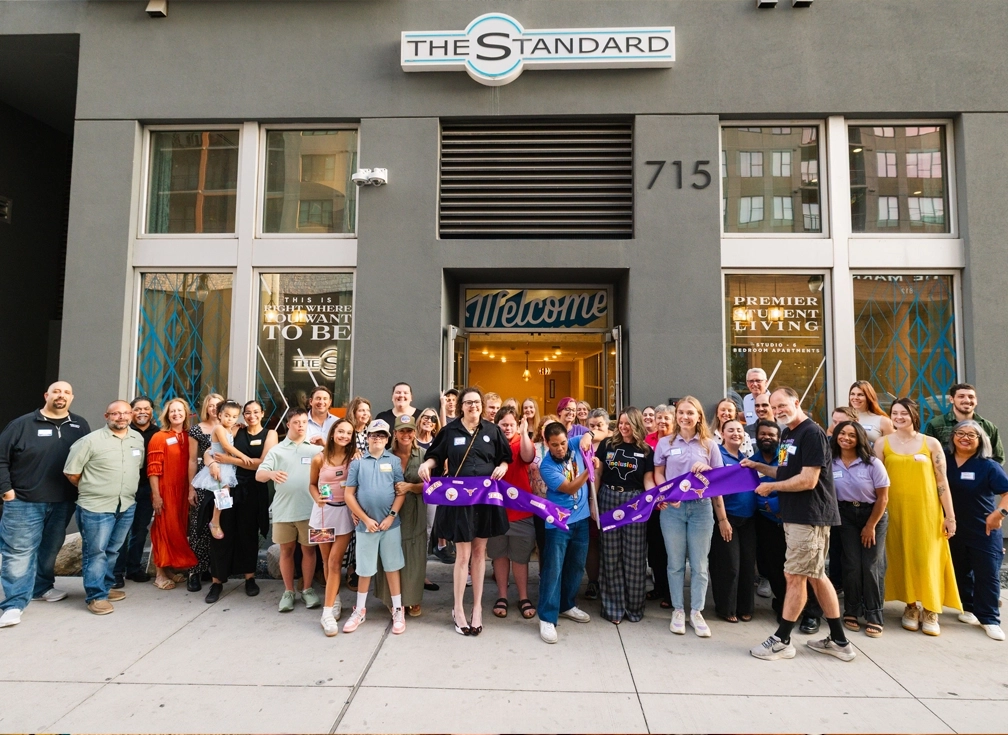 2026 Landmark Residents Post image 1 Best Buddies participants and supporters celebrating with a ribbon cutting outside The Standard residential building.